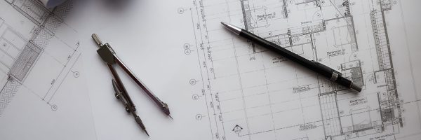 Lifestyle Construction Architectural blueprints for a Toronto renovation lay on the table, accompanied by a pen and a pair of compasses, ready to bring new life to the project. Home Renovation In The GTA